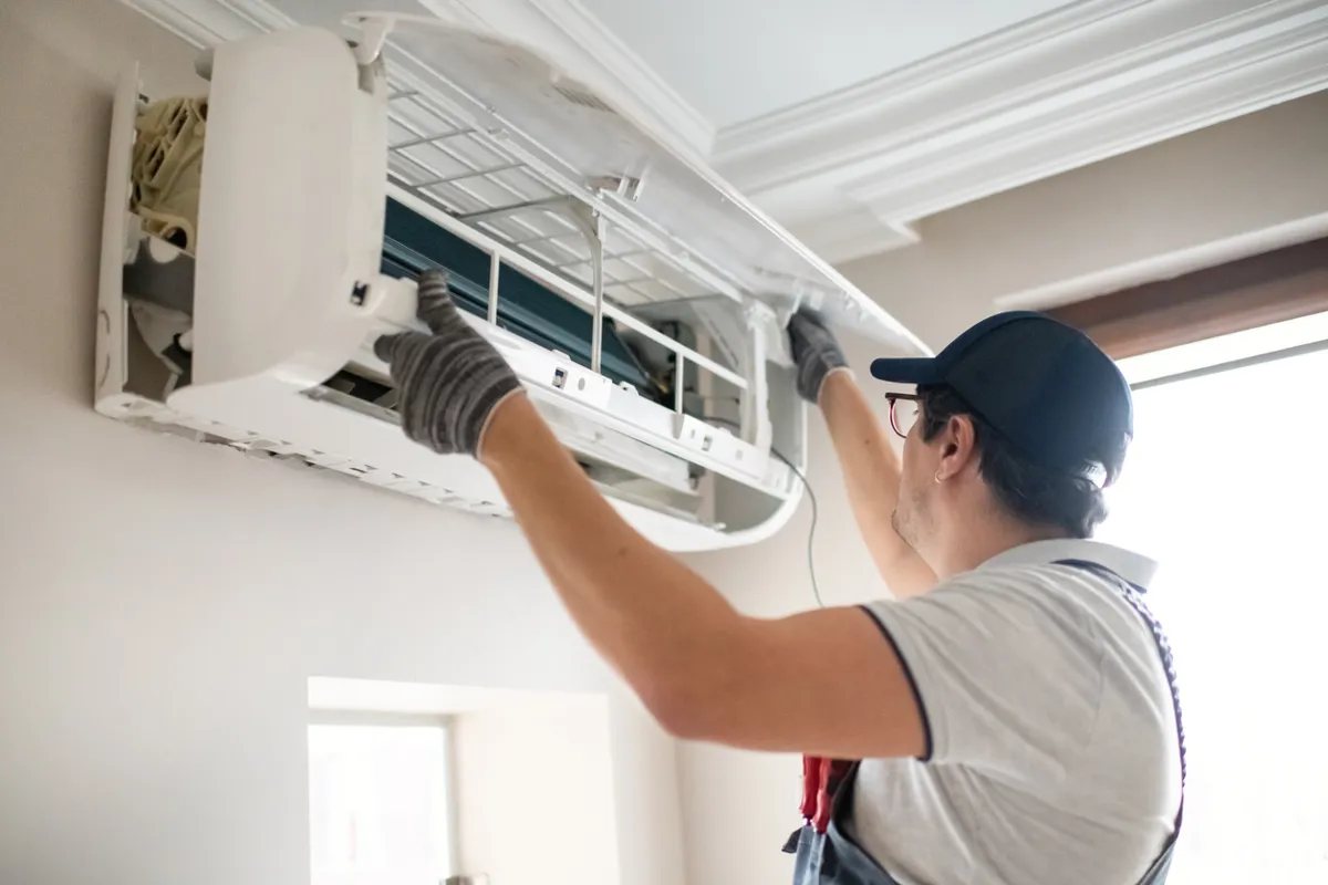 Blue Dot technician installing a ductless HVAC system in an older historic home in Maryland.