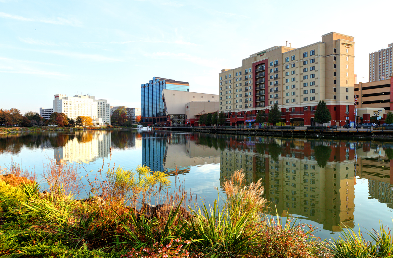 Daytime view of the Gaithersburg, MD, skyline reflecting on a pond along the Washingtonian waterfront.