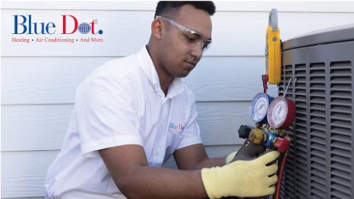 A Blue Dot technician working on an outdoor HVAC unit.