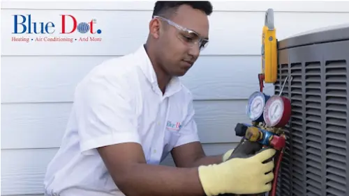 A Blue Dot technician working on an outdoor HVAC unit.