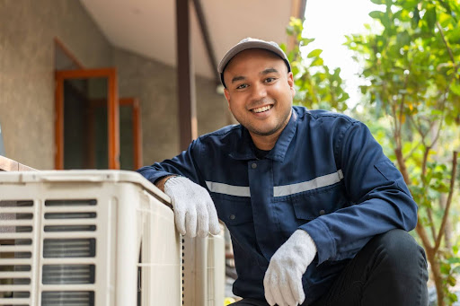 HVAC tech smiling after installing a new HVAC unit